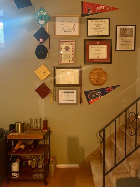 Living room gallery wall for diplomas and accomplishments Accomplishment Wall, Diploma Wall Decor, Diploma Wall, Living Room Gallery Wall, Room Gallery Wall, College Walls, Gallery Wall Living Room, Boston University, Guest Bedroom