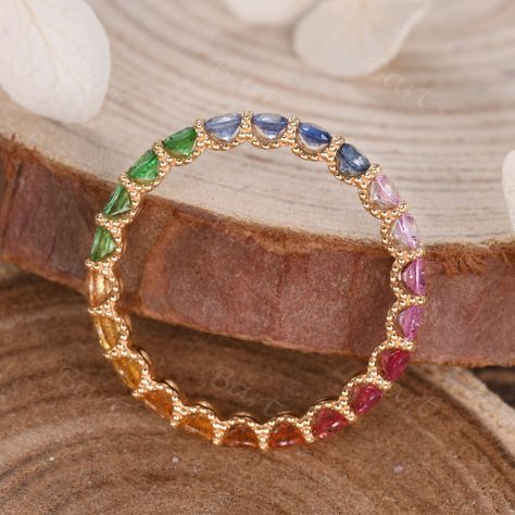 A beautiful gift for Mom, this colorful Scalloped Pave Rainbow Sapphire Eternity Band is a true celebration of family. The full eternity rainbow sapphire band is designed with beaded decor & scalloped pave, making the Eternity Ring in Rainbow Sapphire stronger & suitable for everday wear. ◆ Product Specifications ※18K Rose gold ※Rainbow Color Natural Sapphire, 2.0mm Round Cut ※Setting: Scalloped Prong ※Made in the USA ★Procedure information Please select the style, material, and size from the dr Rainbow Eternity Ring, Rainbow Wedding Ring, Colorful Wedding Band, Beaded Decor, Sapphire Eternity Band, Sapphire Eternity Ring, Rainbow Ring, Rainbow Sapphires, Rainbow Rings