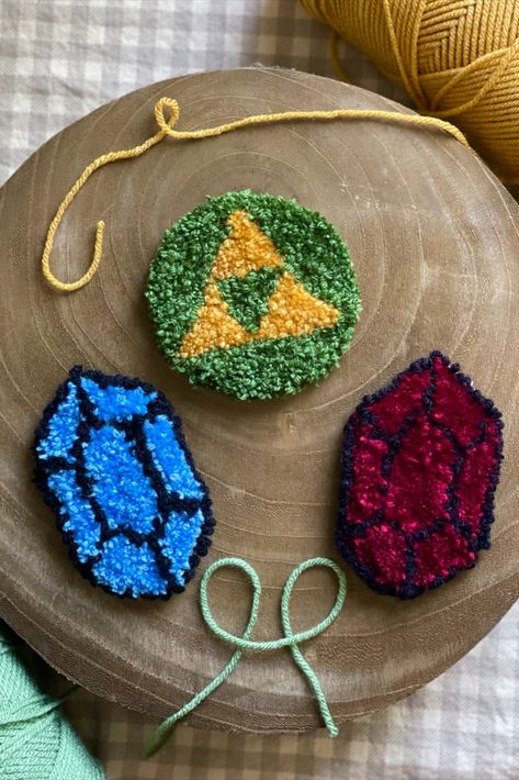 legend of zelda coasters!   hand punch needle, punch needle, handmade, loz, coasters, handmade coasters, handmade gift, punch needling, gamer gift ideas, gift ideas, punch needle ideas, triforce, tri force, link, cute birthday ideas Zelda Gift Ideas, Zelda Gifts, Punch Needling, Cute Birthday Ideas, Yarn Inspiration, Handmade Coasters, Needle Punch, Needle Art, Gamer Gifts