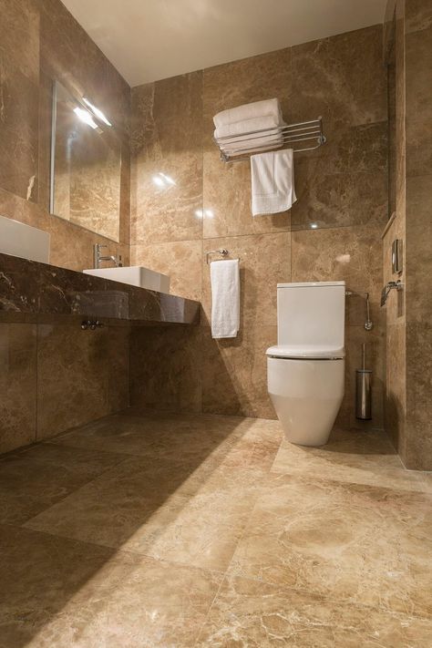 The bathrooms feature marble such as Giallo Antico and Emperador Dark vanities. #marble #gialloantico #emperadordarkvanities #halmannvella Dark Beige Bathroom, Tan Marble Bathroom, Brown Marble Bathroom, Brown And Beige Bathroom, Beige And Brown Bathroom, Beige Marble Bathroom, Brown Tile Bathroom, Cosy Bathroom, Master Baths