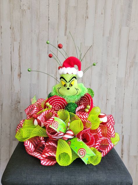 "Grinch inspired centerpiece This will be made to order. Basic design will be as pictured some variations may occur. Choose fluffy grinch or Green monster heart 12\"x13 Fluffy monster 12\"x10\"" Monster Centerpieces, Centerpiece For Christmas, Elf Centerpieces, Monster Wreath, Diy Christmas Candy, Grinch Decorations, Nutcracker Decor, Grinch Christmas Decorations, Peppermint Christmas