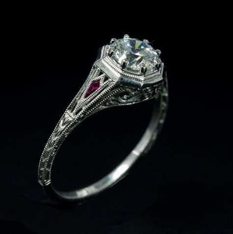 This handcrafted engagement ring has beautiful scroll work along the shaft. The added genuine ruby gives this engagement ring a touch of playfulness, the perfect symbol of your bride. The matching band is not included, But it can be ordered separately. * Silver sample is available upon request, Please contact for the details. Specifications: *Can accommodate  6.00 mm round cut center stone *Available in 14K or 18K white gold *0.06 CT genuine ruby  *Can be made in any ring size, simply contact us Edwardian Engagement Ring Gold, Antique Inspired Wedding, Art Deco Engagement Ring Set, Antique Inspired Engagement Rings, Milgrain Engagement Ring, Edwardian Engagement Ring, Handcrafted Engagement Ring, Ruby Ring Gold, Antique Engagement Ring