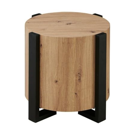 Meet your new favorite sidekick, the Steve Silver Darcie faux-wood end table. This sleek piece brings a mix of modern and architectural flair to any chair or living room area with its' natural looking wood finish and black iron legs. With clean lines and a 24-inch round top, it offers convenient and stylish support without those pesky corners that always seem to get in the way. Its flowing yet assertive profile adds just the right touch of personality to any space. Elevate your room with the Dar Round Wood Table, Unique End Tables, Wood End Table, Living Room Area, Living Room Side Table, Wood End Tables, Living Room End Tables, Modern Side Table, Wood Rounds