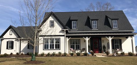 Alabaster Siding; Tricorn Black trim; Wild Currant front door; White windows; Black metal roof; Moire Black shingles Vinyl Siding Window Trim, White Craftsman House, Tricorn Black Front Door, White House Black Trim, House With Front Porch, Black Metal Roof, Metal Roof Houses, Tricorn Black, Farm Style House