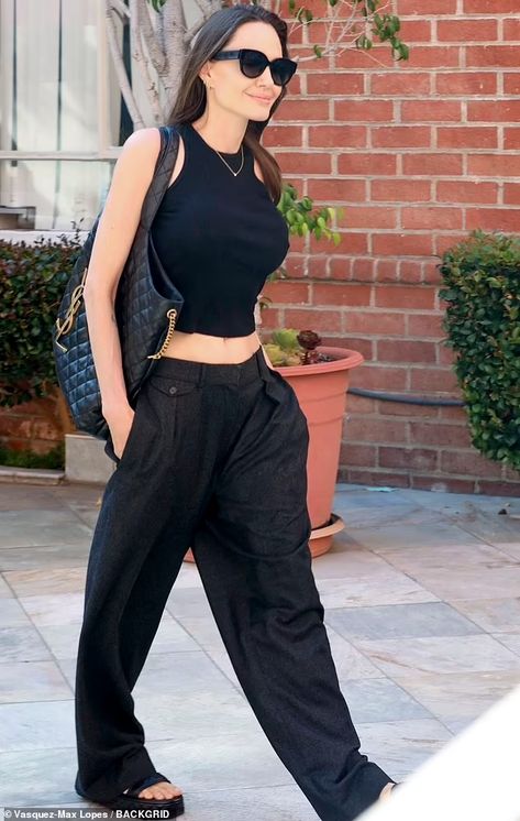 Angelina Jolie flashes her taut tummy in Lara Croft-inspired top as she steps out in Beverly Hills | Daily Mail Online Angelina Jolie Body, Angelina Jolie Style, Angelina Jolie Photos, Black Crop Top Tank, Tank Top Outfits, Feminine Outfit, Angelina Jolie, Black Tank Tops, Look Fashion