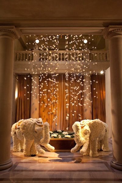 Love this modern indian wedding idea - elephants at the venue entrance (in white flowers) and hanging flowers from the ceiling. Brings such elegance and romance to the venue - it's modern yet still Indian. Great idea for fusion wedding decor too! Hindu Wedding Decorations Indian Theme, Bollywood Night, Egyptian Wedding, Modern Indian Wedding, Kerala Wedding, Indian Wedding Inspiration, Wedding Mandap, Big Fat Indian Wedding, Fusion Wedding