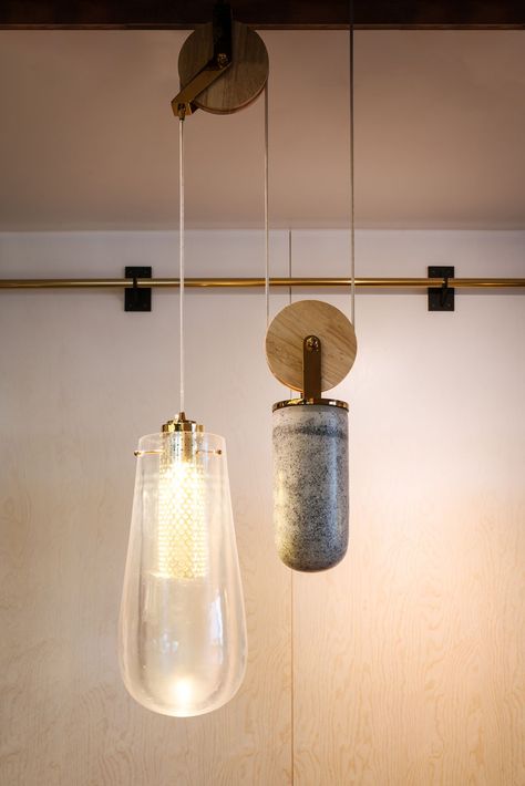 The custom-designed pendant lights that are on a pulley system, consist of a drop pendant light made from cast resin, a counterweight made from cast concrete, and brass details with a diffused COB LED light within. Pulley Light Fixture, Mountain House Design, Pulley Light, Drop Pendant Lights, Custom Light Fixtures, Bulb Pendant Light, Hanging Light Fixtures, Shanghai China, Restaurant Interior Design