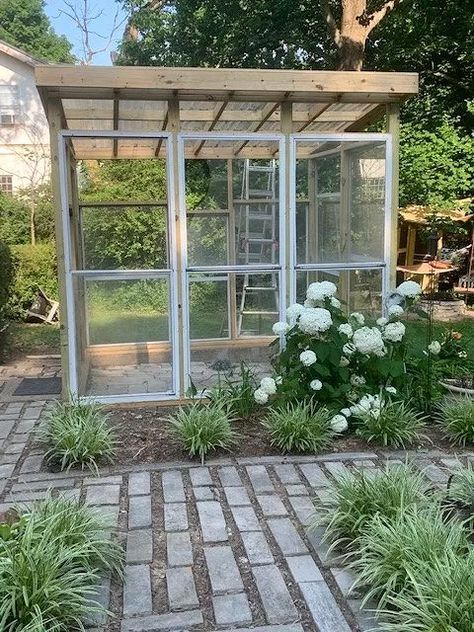 A friend gave us storm windows and we designed a green house from what we were given. Purchased treated lumber posts and 2x4's to frame the house. Used Plexiglas for the upper windows and roof. Purchased wire shelving to install 4 nine foot shelves. The stone floor was already set from the previous greenhouse. It measures 8 /2 'x9 1/2'. Acquired storm windowsAfter much internet searching and figuring, we came up with a different plan for our greenhouse. Starting to frame out the hou… Greenhouse Frame Ideas, Walkway Pattern, Diy Faux Rocks, Recycled Windows, Rock Planters, Window Greenhouse, Concrete Stepping Stones, Portable Greenhouse, Storm Windows