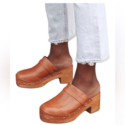 The Free People Calabasas Tan Leather Studded Clogs Are Here To Be Your New Closet Fave! These Trendy Clogs Have A Lightly Distressed Genuine Leather Composition That Shapes A Rounded Toe And A Curved Topline With A Strap Accent. Antiqued Studs Trim Along The Wooden Heel With A 1.75" Toe Platform. Slide-On Design. Available In Euro Sizes Only. 3" Wood Block Heel. Cushioned Insole. Rubber Sole Has Nonskid Markings. Genuine Leather Upper, Lining & Sock. Balanced Man Made Materials. Imported. Style Free People Clogs, Mules Shoes Flat, White Clogs, Studded Clogs, New Closet, Clog Boots, Wooden Clogs, Platform Clogs, Suede Block Heels