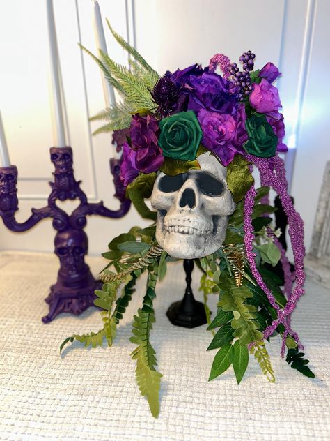 Gorgeous and unique! Beautiful jewel tones of purple and green. Sits on a solid black candlestick base. Purple skull candelabra that holds 3 candles is included!  This skull candlestick is a perfect gift, Halloween decoration, or a Halloween wedding decor for that extra special touch. Sizing/Dimensions 10 inches wide and 21 inches tall Features: Lightweight Durable Orange Black Purple Green Halloween Decor, Purple Witchy Wedding, Green Pumpkin Decor, Skull Wedding Decorations, Purple Halloween Decor, Haunted Halloween Decorations, Halloween Wedding Decor, Skull Vase, Halloween Centerpieces