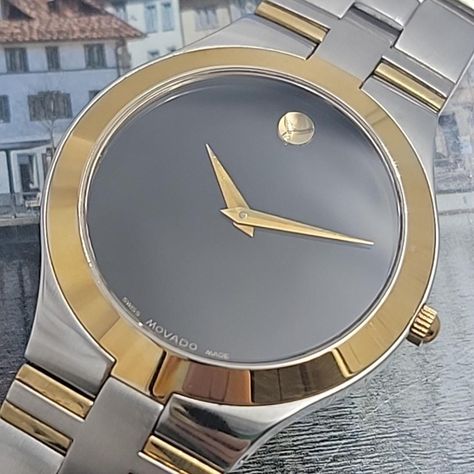 This Movado Museum wristwatch for men features a striking gold-tone fixed bezel on a silver stainless steel case. The black dial with silver accents and a quartz movement make it a versatile watch for both dressy and casual occasions. The scratch-resistant sapphire crystal protects the dial and the push/pull crown allows for easy adjustment of the time. The 20mm stainless steel band completes the look of this classic and timeless watch. New Battery Installed Excellent Running Condition Expect some normal daily wear scratches Timeless Watch, Timeless Watches, Watch New, Clean Face, Stainless Steel Band, Silver Accents, Wristwatch Men, Wrist Watches, Sapphire Crystal