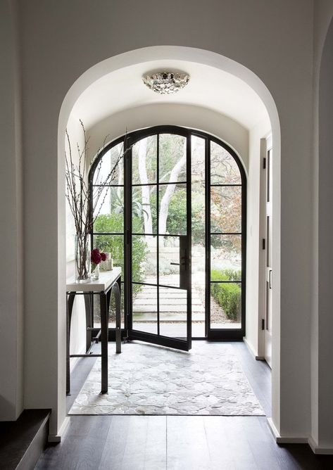 I am torn…I love a glass front door…specifically these steel framed doors…they let in light and bring character into a space from the moment you walk in.  I am torn though as to whether I would want a glass front door.  Have been considering this lately.  You lose privacy…gain light…is safety an issue?…or is style Read More Jenkins Interiors, Arched Doorway, Iron Front Door, Steel Front Door, Grand Entry, Steel Windows, Spanish Style Home, التصميم الخارجي للمنزل, Expensive Taste