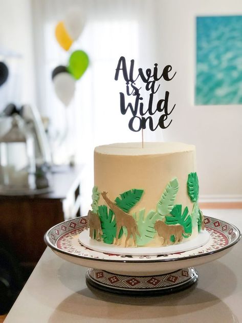 Alvies Wild One Birthday Party | Cute safari cake and custom topper for Alvies first Birthday | A Visual Merriment #safari #kidsparties #boysparty #partytheme #diyparty #partyplanning #one #diypartyideas #cake #birthdaycake #cake topper Wild One Smash Cake Boys, Wild One Cake Ideas, Jungle Cakes, Wild One Cake, Safari Cake, Inside Cake, Wild Birthday Party, Wild Party, Elephant Cakes