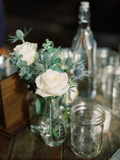 White roses and blue thistle in vintage bud vases for a simple wedding tablescape. #weddingflowers #weddingflowerinspiration #sanfranciscoweddingplanenr #newyorkweddingplanner Thistle Centerpiece, Wedding Bud Vases, Vintage Bud Vases, Wedding Table Vases, Bud Vases Wedding, Starry Wedding, Thistle Wedding, Small Wedding Bouquets, Xmas Table Decorations