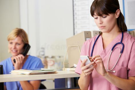 Nurse Using Mobile Phone At Nurses Station. Standing #Sponsored , #advertisement, #ADVERTISEMENT, #Mobile, #Standing, #Station, #Nurse Nursing Informatics, Nurse Jackie, Nurses Station, Healthcare Jobs, Nursing Profession, Nurse Rock, Practical Nursing, Nursing Memes, Travel Nursing