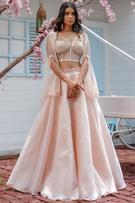 Featuring a blush pink lehenga in organza and taffeta silk base. It is paired with a matching corset top and a cape.   FIT: Fitted at bust and waist. COMPOSITION: Organza, Taffeta silk. CARE: Dry clean only. Cape Lehenga, Organza Jacket, Embroidered Cape, Designer Sarees Wedding, Organza Lehenga, Corset Blouse, Lehnga Dress, Pink Corset, Pink Lehenga