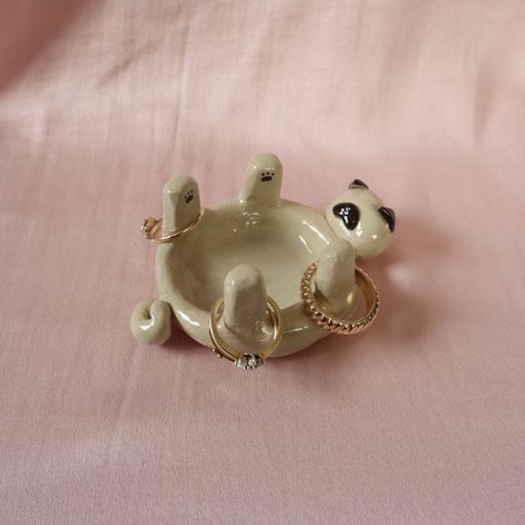 Pug jewellery holder/trinket dish. Handmade using air dry clay, painted and topped with a shiny varnish.  All products are unique and handmade by myself. Made with care and a special attention to detail ✨ Please note - since each product is hand crafted and hand painted, there may be small imperfections that make each piece unique and special.  💧Water resistant but not waterproof 💧 Clay Air Dry Diy, Clay Pottery Jewelry Holder, Clay Art Useful, Useable Clay Projects, Practical Air Dry Clay Projects, Easy Clay Jewelry Dish, Usable Clay Projects, Dog Trinket Dish, Pinch Pot Jewelry Holder