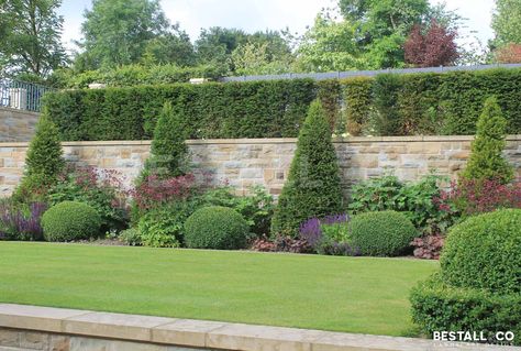 Italian terraced garden - This large formal scheme displays symmetry & balance. A twin York Sandstone spiral staircase rises from the first terrace, elevating visitors to the second terrace garden. A selection of formally planted level areas create smaller, more intimate rooms, where perfect topiary and beautiful stone pots are placed to make the most of each vista. With resting places scattered around this Yorkshire garden, you have many places to sit and relax. Tiered Landscaping, Italian Garden Ideas, Yorkshire Garden, Steep Gardens, Terraced Garden, Sloped Backyard Landscaping, Sloped Backyard, Terrace Garden Design, Landscaping Retaining Walls