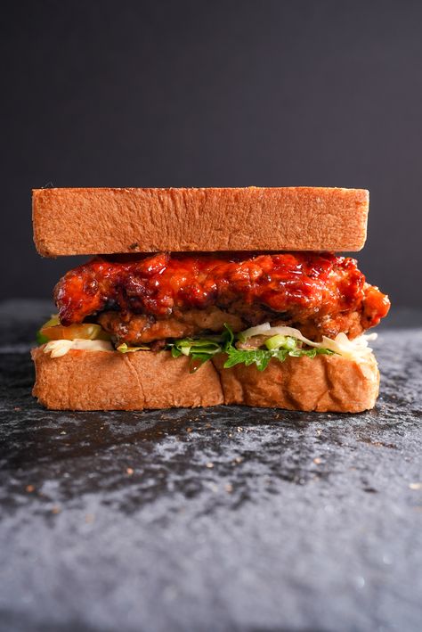 Korean Fried Chicken Sandwich Korean Chicken Sandwich Recipes, Korean Fried Chicken Sandwich, Kimchi Slaw, Shiso Leaves, Ultimate Sandwich, Sticky Sauce, Beer Chicken, Korean Chicken, Buttermilk Fried Chicken