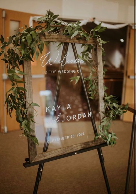 Make a statement by greeting your guests warmly with this stylish acrylic wedding welcome sign. This custom designed framed in a dark wood finish makes for a nice addition to a rustic Boho decor. The sign is available in an array of sizes and frame options. Welcome To My Wedding Sign, Glass Wedding Welcome Sign, Welcome To Our Wedding Wood Sign, Welcome Sign Wedding Picture Frame, Wedding Glass Welcome Sign, Wedding Signs With Greenery, Welcome Signs For Wedding Entrance, Wedding Welcome Sign Picture Frame, Picture Frame Welcome Sign Wedding