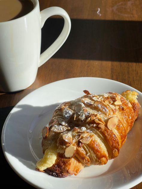 An almond croissant inside of a coffee shop next to a cup of coffee Chocolate Deserts, Almond Croissant, Food Babe, Food Platters, Cafe Food, Food Menu, Easy Snacks, Cute Food, No Bake Desserts