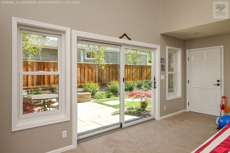 Large new sliding patio door and double hung windows we installed in this great family room. These new white replacement windows along with new sliding glass door open up from the family room to a wonderful patio. Find out more about replacing the windows and doors in your home from Renewal by Andersen of San Francisco Bay Area, California. Patio Door With Windows On Each Side, Sliding Glass Door With Windows On Side, Kitchen 2025, Screened Deck, Glass Patio Door, French Doors Patio Exterior, Replacement Patio Doors, Window Solutions, Diner Ideas