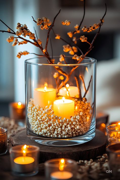 Cozy living room decor idea featuring a glass vase with lit candles, popcorn filler, and autumn branches, creating a warm fall ambiance. Simple Fall Centerpieces For Table, Pastel Fall Decor, Simple Fall Decor, Pastel Fall, Cooking Decor, Autumn Treats, Rustic Arrangements, Cheap Fall Decor, Decorate For Fall