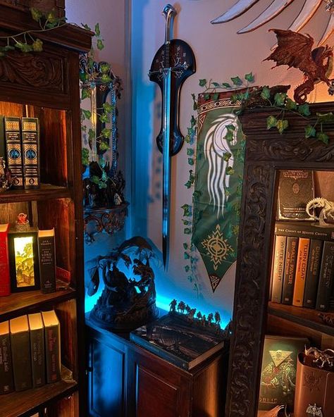 Koriel Aesthetic on Instagram: "Here is the little corner between 2 of my favorite wood carved bookshelves in the Great Room. Sometimes these corner spaces can be awkward to try to fill, but my current solution seems to work for now ☺️ Perhaps in the future I will find a matching corner shelf on marketplace to tie the shelves together! I do like having this little nook for displaying a few of our Lord of the Rings pieces, as well as the Game of Thrones Costumes book that I adore. The small cupbo Game Of Thrones Collection Display, Lord Of The Rings Decor, Game Of Thrones Costumes, Dnd Minis, Game Of Thrones Books, Small Cupboard, Ring Game, Corner Space, Fantasy Decor