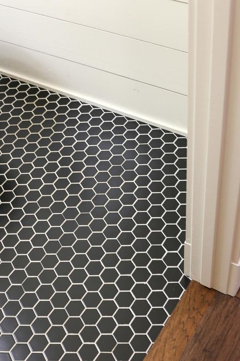 A black hexagon tile floor with white grout and shiplap walls. Black Hexagon Tile Floor, Hexagon Vinyl Flooring, Black Hexagon Tile Bathroom, White Hexagon Tile Bathroom, Hex Tiles Bathroom, Hexagon Tile Bathroom Floor, Hexagon Tile Bathroom, Black Hexagon Tile, Black Tile Bathrooms