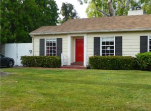 A quick home project is to paint our front door to make it inviting and also to change the look and feel of our homes. A fresh paint is a style. Brown Roof Black Shutters, Yellow House Brown Roof, House Shutter Colors, Taupe House, Yellow House Exterior, Red Door House, Brown Roofs, Green Roof House, Tan House