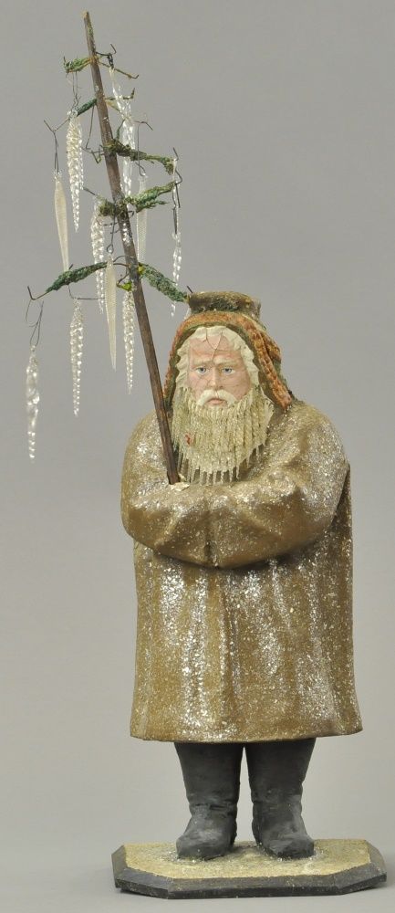 Large German Santa Claus candy container with  glass beard, composition figure wearing long brown  robe flecked with mica, golden beads around his  hood, holding lichen moss tree in arms, standing  on mica flecked wood base, kind expression and deep blue eyes. 16" h. Recent attic find, had some  minor leg problems and has  some age crazing on face, tree shows age related  wear. German Santa Claus, Deep Blue Eyes, Moss Tree, Christmas Antique, Santa Klaus, Santa Claus Figure, Lichen Moss, Christmas Santas, Primitive Santa