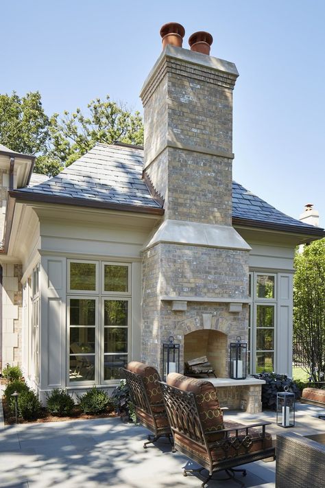 Set between floor-to-ceiling windows, this neutral brick fireplace adds elegance to a welcoming outdoor area from Reynolds Architecture, Design & Construction. #outdoorfireplace #patio #outdoorlounge Transitional Fireplace, Design Fireplace, Fire Design, Outdoor Fireplace Designs, Backyard Fireplace, Outside Living, Fireplace Ideas, Floor To Ceiling Windows, Brick Fireplace