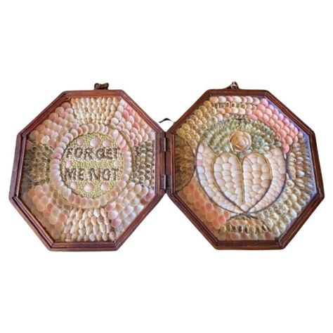 Antique Double Sailor's Valentine, circa 1880, a pair of handcrafted shell collages mounted in mahogany octagonal shadowboxes, hinged together and mounted with a clasp and a chain for hanging. This valentine features a heart and the message "Forget Me Not." The valentine is in great condition, but does of course have a few shells that have come loose over the past century and a half. The cases remain in great condition as well. Each Measures: 9-1/8 in H x 9-1/8 in W Victorians in the Age of Exploration and its accompanying Eclectic Movement embraced arts and crafts from around the world. Shell boxes are frequently seen, and even the odd shell diorama, shell constructed flower basket or bowl, or even a shell adorned piece of furniture. Much more elaborate and sophisticated, and prized, are Crafts From Around The World, Age Of Exploration, Contemporary Folk Art, Sailors Valentine, Sea Snail, Bridgetown, Compass Rose, Shopping Photography, Home Again