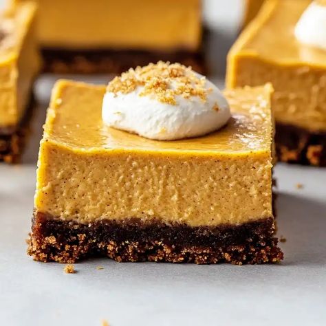 Discover the perfect fall dessert with our pumpkin cheesecake bars with gingersnap crust. Creamy pumpkin filling meets crunchy gingersnap crust Gingersnap Pumpkin Cheesecake, Pumpkin Ginger Snap Cheesecake, Pumpkin Cheesecake Gingersnap Crust, Pumpkin Cheescake, Ginger Snap Crust, Pumpkin Filling, Pumpkin Cheesecake Bars, Gingersnap Crust, Pumpkin Cheesecake Recipes