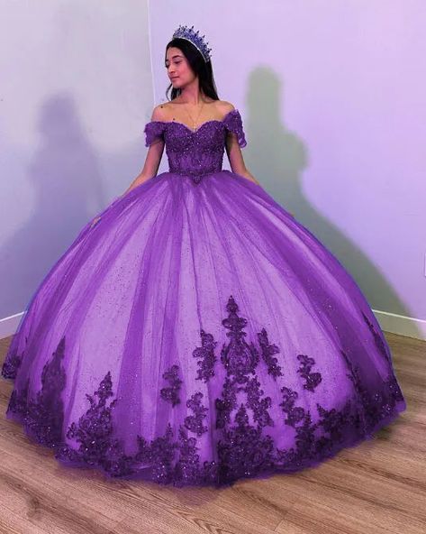 Step into your dream Quinceanera with the Fiora Ball Gown. This exquisite gown features a classic ball gown silhouette, beautifully crafted from layers of luxurious tulle fabric that add volume and movement to your every step. It is available in vibrant colors like royal blue, red, pink, purple, and green. The lace-up back ensures a perfect fit, accentuating your figure while adding a touch of classic charm. The intricate applique details and delicate beading sparkle with every turn, making you Dark Purple Quince Dresses, Dark Purple Quinceanera Dresses, Off The Shoulder Quinceanera Dress, Dream Quinceanera, Purple Quinceanera Dresses, Quinceanera Themes Dresses, Gown Silhouette, Quinceñera Dresses, Purple Wedding Dress