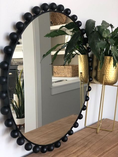 How to get a designer looking mirror for way less cost! I love love love the look of these mirrors but I was positive I could find a way cheaper way to make one on my own. so let’s do this! I started off with this mirror that I found for $58 I absolutely love the size of this one, honestly you can use any round mirror for this project. Next I found these wooden rounds (without holes) I have seen so many people using the wooden round balls with holes in the for projects but the… Diy Frame For Round Mirror, Round Beaded Mirror, Round Mirror Wall Decor Ideas, How To Make A Round Mirror Frame, Oval Wall Decor, Round Mirror Frame Diy, Round Mirror Decor Ideas, Bead Wall Art, Diy Round Mirror