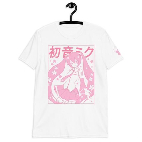 A pastel pink Sakura Miku Tee, with a Yume Kawaii vibe!  Printed via Direct-to-Garment method for a matte finish that blends well with the fabric without excess edges. American sizing! Size chart on the last image. ❤ 100% ring-spun cotton ❤ Pre-shrunk ❤ Shoulder-to-shoulder taping ❤ Blank product sourced from Bangladesh, Honduras, Haiti, Mexico, or Nicaragua Pink Shirt Aesthetic, Miku Shirt, Pastel Color Shirts, Fairycore Shirt, Cute Cherry Blossom, Cherry Blossom Shirt, Kawaii Spring, Kawaii Summer, Sakura Miku