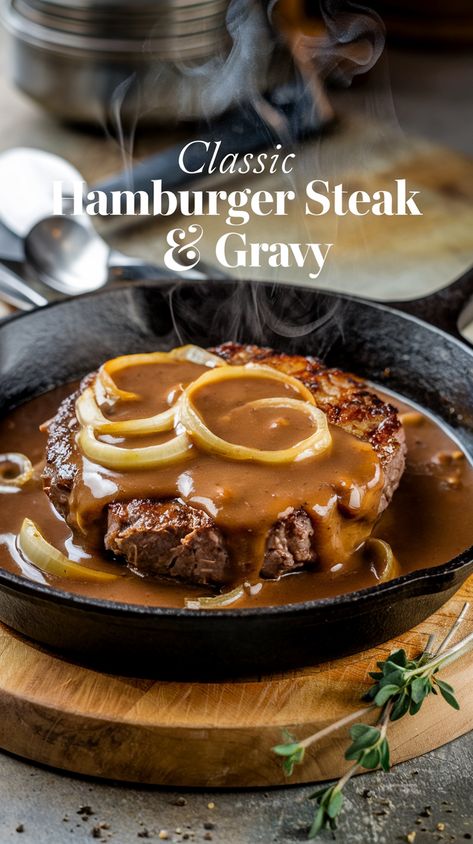 Juicy hamburger steak with rich onion gravy and caramelized onions, served in a rustic cast iron skillet under warm light, garnished with fresh thyme and cracked black pepper. Hamburger Steak With Onion Gravy, Bisquick Banana Muffins, Eggnog Pancakes Recipe, Hamburger Steaks With Onion Gravy, Onion Gravy Recipe, Hamburger Steak And Gravy, Hamburger Steaks, Apple Dumpling Recipe, Banana Muffin Recipe