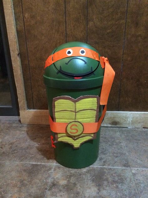 Ninja turtle Valentine's Day box made from trash can cardboard, spray paint, and ribbon Painting Trash Cans Ideas, Tmnt Valentine Box Ninja Turtles, Trash Can Valentine Box Ideas, Turtle Valentine Box Ideas, Valentine Box Ideas, Valentines 2024, Kids Valentine Boxes, Boys Valentines, Valentine Card Box