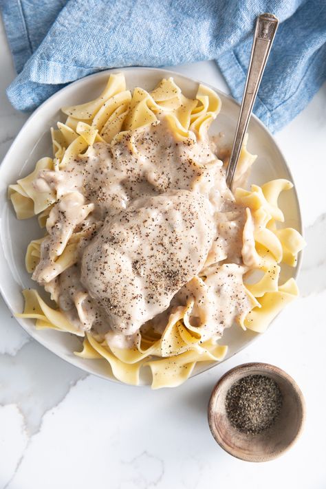 My dad's cream of mushroom pork chops are a family favorite. Made with pan-seared pork chops and cream of mushroom soup, this fast and easy weeknight dinner is best served with a side of egg noodles and sweet corn and is perfect for any family craving a little comfort food. Cream Of Mushroom Pork Chops, Mushroom Soup Pork Chops, Smothered Pork Chops Recipe, Pan Seared Pork Chops, Mushroom Pork Chops, Seared Pork Chops, Apple Pork Chops, Crockpot Pork Chops, Smothered Pork Chops