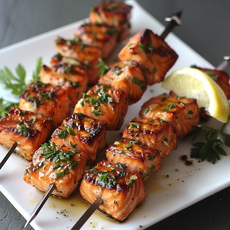 🐟 Grilled Salmon Kabobs: Delight in these flavorful salmon kabobs, perfect for a healthy, grilled treat. #GrillGoals Grilled Salmon Kabobs Ingredients: Salmon fillets, cubed (2 cups (300g)) Olive oil (2 tbsp (30ml)) Lemon juice (1 tbsp (15ml)) Garlic, minced (1 tsp (5ml)) Salt and pepper (to taste) Skewers Instructions: Marinate salmon in olive oil, lemon juice, garlic. Thread onto skewers. Grill until cooked through. 🔥 Fresh, flavorful, and fantastically grilled! #SalmonKabobScene Salmon Kebabs Skewers, Healthy Kabobs, Marinate Salmon, Grilled Salmon Kabobs, Salmon Kabobs, Watercress Recipes, Salmon Skewers, Healthy Grilled, Salmon Spices