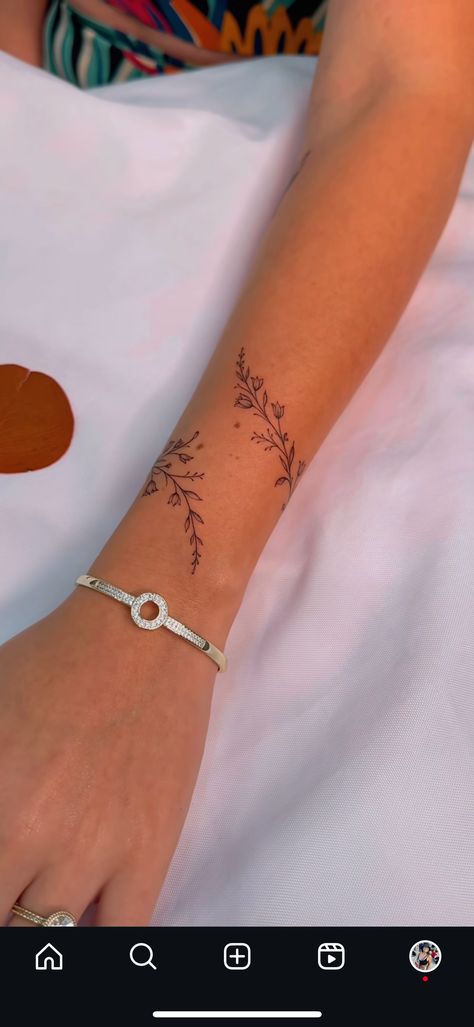 Minimalist Boho Tattoo Ideas, Dainty Flower Arm Tattoos For Women, Tattoos On The Side Of Hand, Astrological Hand Tattoo, Wrap Around Flowers Tattoo, Delicate Flower Arm Tattoo, Fine Line Tattoo On Wrist, Tattoos That Wrap Around Wrist, Flower Chain Tattoo Arm