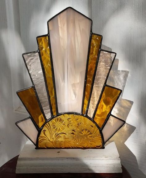 Ivy De Bruijn on Instagram: "This week I've been very busy catching up with all my commissions that i took on for Christmas orders, but i think next week will be all about Art Deco, sun's and Lalique's for a shop update... 💛 This piece is a commision and I love how it turned out, so I am going to make a few more. What do you say? Are you after an art deco creation? I have so much beautiful vintage and or old textured glass available 😍 . . . . . . #stainedglassart #stainedglasssuncatcher #handm Art Deco Patterns Artwork, Art Deco Leadlight, Stained Glass Lamp Patterns, Stained Glass Fan Lamps, Art Deco Stained Glass Patterns, Stained Glass Fan Lamp Patterns, Art Deco Stained Glass Lamp, Art Deco Sun, Stained Glass Mirror Art Deco