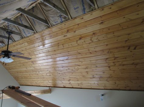 It's fairly common for tongue-and-groove boards to be installed as the interior finish material for an insulated cathedral ceiling.  Although this photo doesn't depict the house described by Erik North, it shows a typical method used to install ceiling boards — a method that pays no attention to air leakage. A better approach is to install a layer of taped gypsum drywall to act as an air barrier before installing the board ceiling. Tongue Photo, Basement Ceiling Insulation, Ceiling Boards, Ceiling Planks, Garage Ceiling, Finished Garage, Tongue And Groove Ceiling, Garage Roof, Plank Ceiling