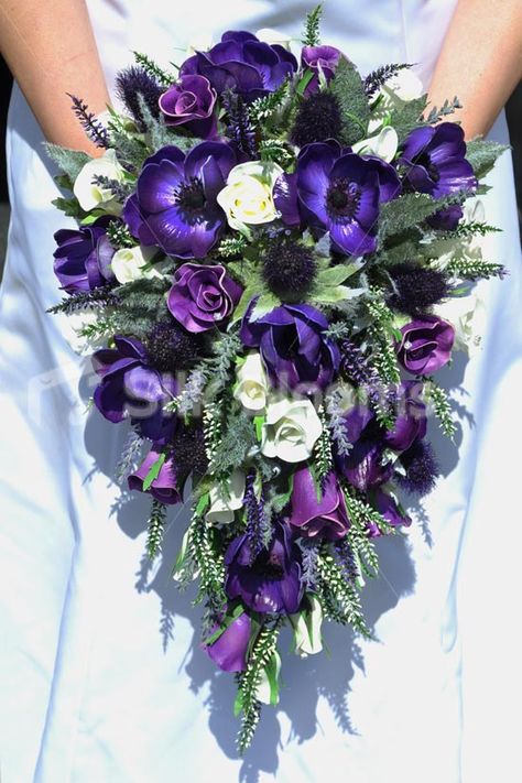 Create a country wedding styled in purple silk anemone and closed foam rose with a spray of thistle and foliage make a cascade bouquet truly individual Purple Cascade Wedding Bouquet, Royal Purple Wedding Bouquet, Purple Cascading Wedding Bouquets, Dark Purple And Green Wedding Flowers, Royal Purple And Emerald Green Wedding, Purple Cascading Bouquet, Bouquet With White Roses, Purple Black Wedding, Royal Purple Wedding