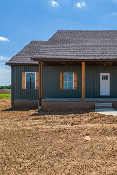 Spruce up your siding and go bold! Dark green siding (color Spruce) with cedar and black accents. Big fan of the dark exteriors. Hunter Green Barndominium, Dark Green Vinyl Siding House, Dark Green Barndominium, Dark Board And Batten Exterior, Dark Green Siding House, Green Barndominium Exterior, Dark Green Home Exterior, Dark Green Siding, Dark Green House Exterior