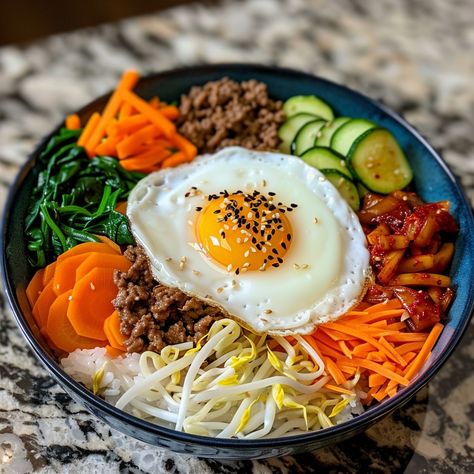 🥢 Dive into the flavors of Bibimbap! 🌶️ #KoreanCuisine #Bibimbap Bibimbap (Mixed Rice) Ingredients: Cooked rice (2 cups) Bean sprouts (1 cup, blanched) Carrot (1, julienned) Spinach (1 cup, blanched) Zucchini (1, julienned) Shiitake mushrooms (1 cup, sliced) Ground beef (1/2 cup, cooked) Kimchi (1/2 cup) Gochujang (2 tbsp) Sesame oil (1 tbsp) Sesame seeds (1 tbsp) Fried egg (1) Instructions: Arrange rice in a bowl. Place vegetables, beef, and kimchi on top. Add gochujang, sesame oil, and ... Kimchi And Rice, Bibimbap Bowl, Kimchi Rice, Bibimbap Recipe, Mixed Rice, Korean Rice, Food Pic, Instagram Recipes, Twisted Recipes