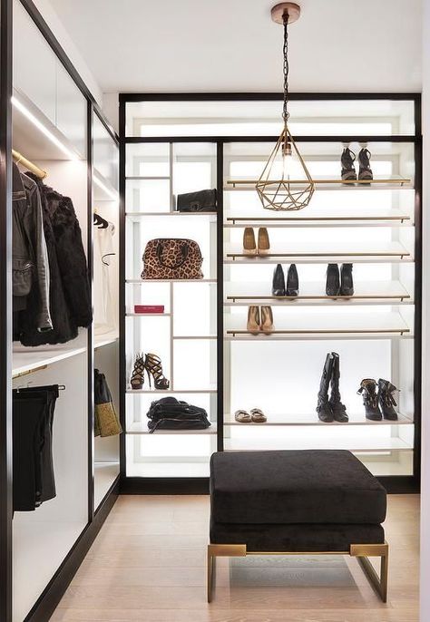 Izen Architecture - Glam black and white walk-in closet features a black velvet ottoman placed beneath a gold geometric pendant in front of black and white slanted shoe shelves with brass rails positioned beside bag display shelves located adjacent to custom lit stacked clothing rails. Black And White Walk In Wardrobe, Black White And Gold Walk In Closet, Black And White Walk In Closet, Black And Gold Closet, Black And White Closet, Gold Closet, Gorgeous Closet, Closet Features, Closet Small Bedroom