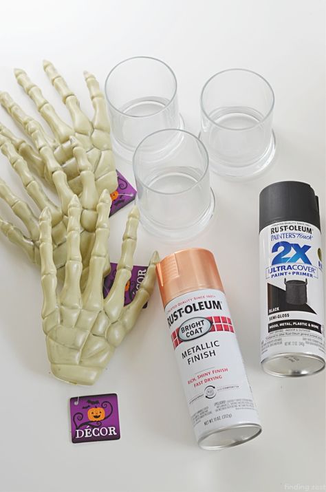 Painted Skeleton Halloween Decorations, Dollar Tree Halloween Skull Decor, Spray Painted Skeleton, Spray Paint Skeleton, Dollar Tree Halloween Candle Holders, Poolnoodle Diy Halloween Candle, Skeleton Hand Candle Holder Diy, Dollar Tree Halloween Candles, Dollar Tree Skeleton Hands