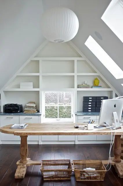 a beautiful attic home office with skylights, a built in shelving unit, a large stained desk, baskets and a sphere pendant lamp Attic Decor, Attic Office, Finished Attic, Cool Office Space, Office Design Inspiration, Loft Office, Small Attic, Attic Flooring, Attic Room